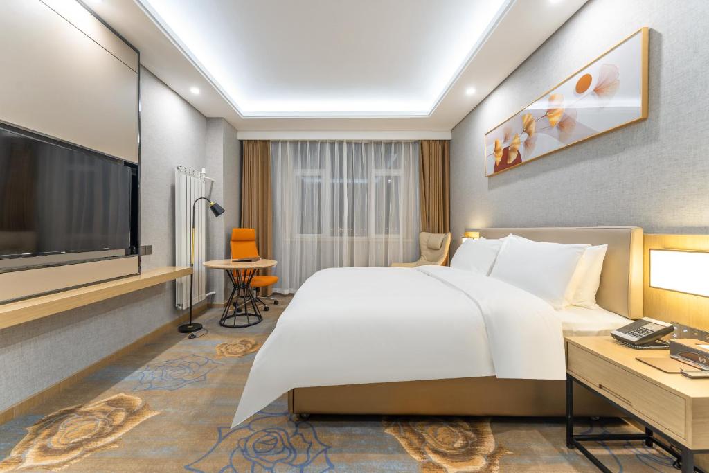 Postel nebo postele na pokoji v ubytování Joy Fall Hotel