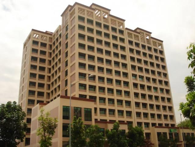a large white building with a lot of windows at Alabang Condotel in Manila