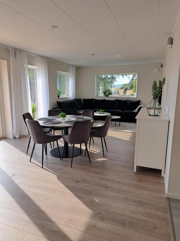 een woonkamer met een tafel en stoelen en een bank bij Tångaberg, Varberg in Varberg