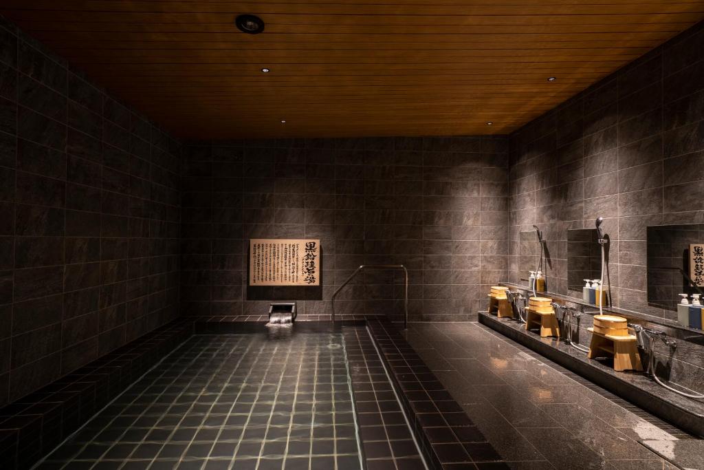 a room with a swimming pool in a building at Waqoo Naritasanmonzen in Narita
