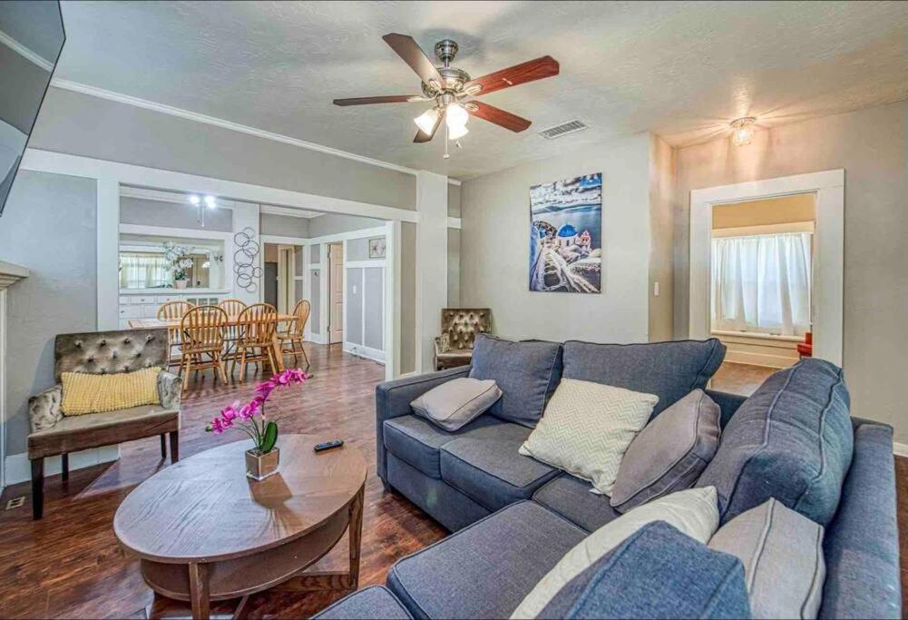 a living room with a blue couch and a ceiling fan at 2 King Beds! Fantastic Stylish Bungalow home! in Fresno