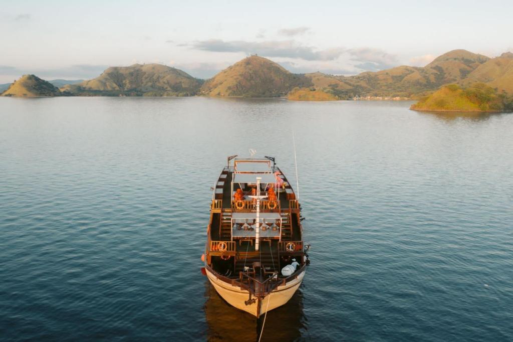 a boat sitting in the middle of a body of water at Family Labuan Bajo in Labuan Bajo