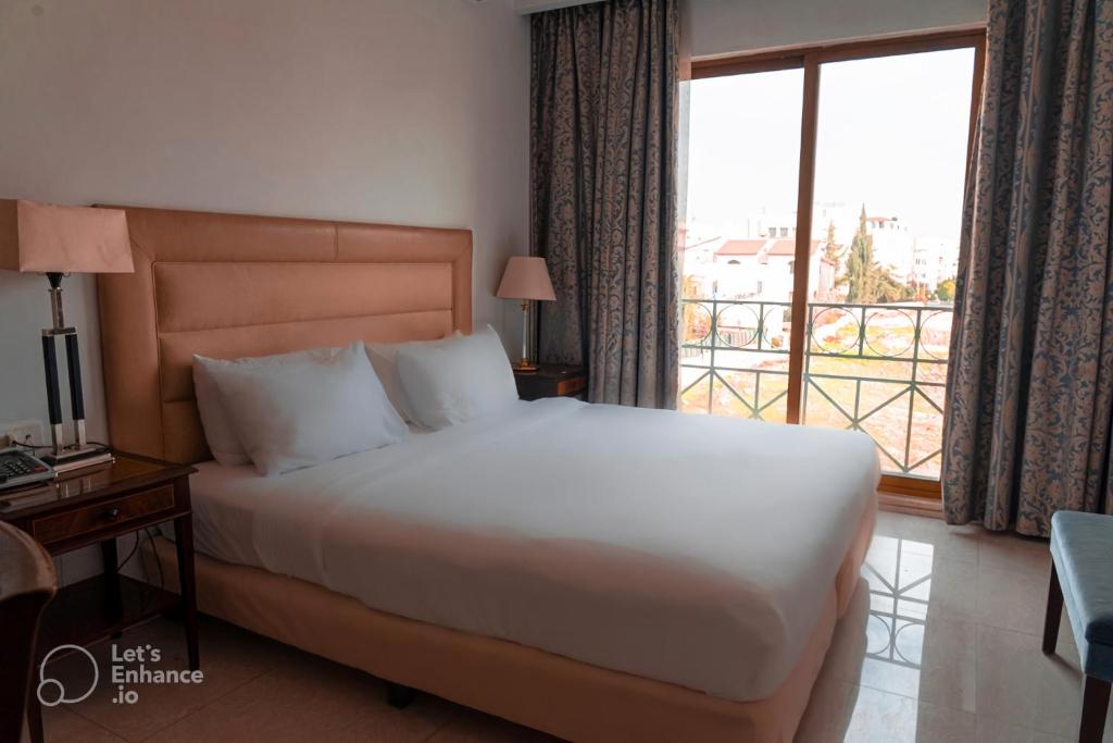 Ένα ή περισσότερα κρεβάτια σε δωμάτιο στο Guest House Hotel Amman by FHM