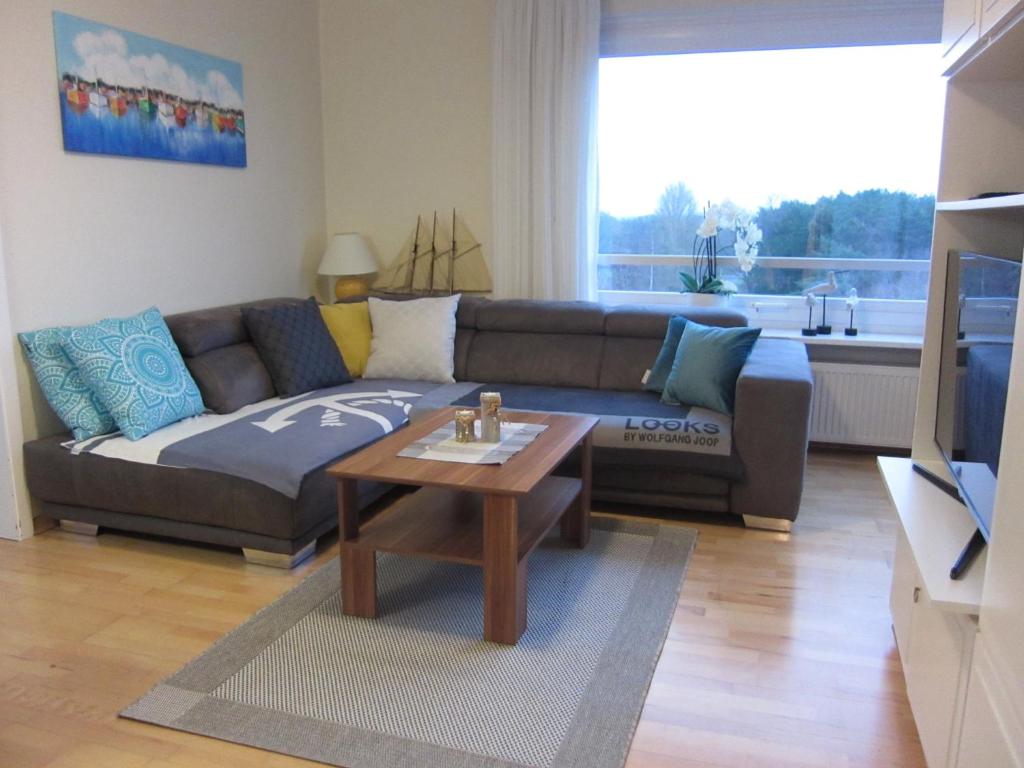 a living room with a couch and a coffee table at Hanseat II - Whg 183 "Meeresperle" in Grömitz