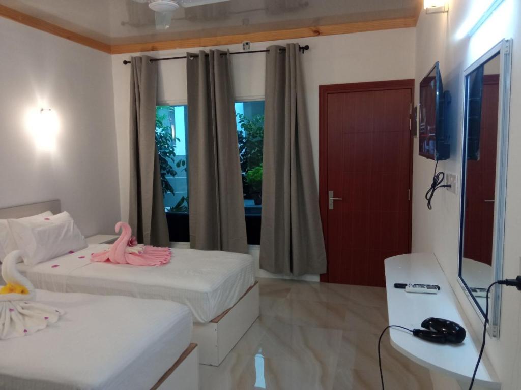 Postel nebo postele na pokoji v ubytování Thoddoo Garden inn