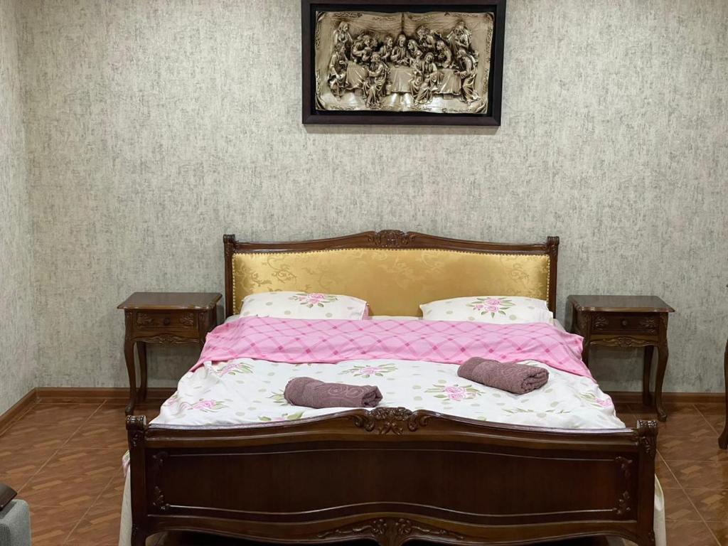 a bedroom with a bed with two pillows on it at Gio Apartment in Tbilisi City