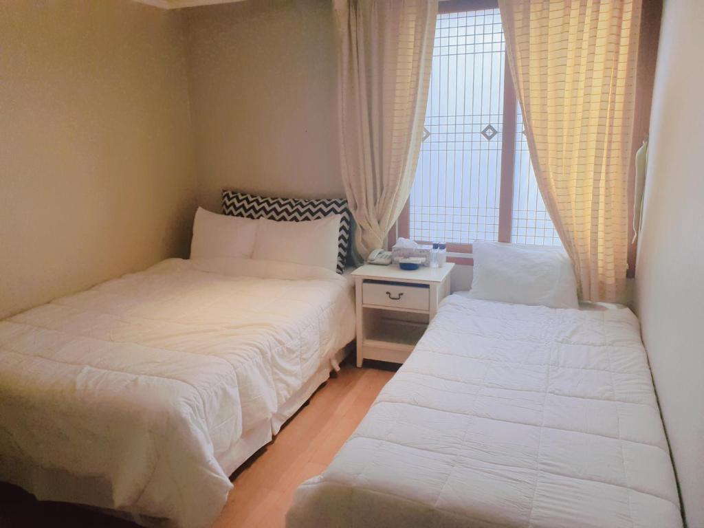 Postel nebo postele na pokoji v ubytování Hotel Good Inn