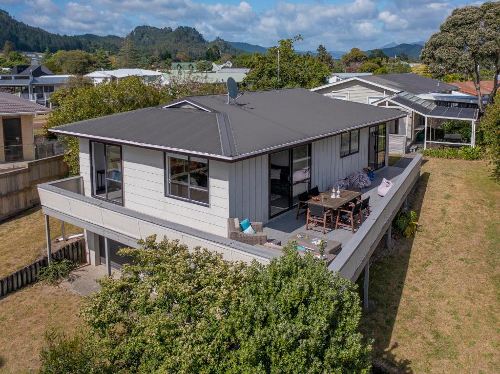 an aerial view of a house with a table at Purely Pauanui - Pauanui Holiday Home in Pauanui