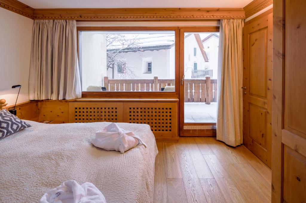 Postel nebo postele na pokoji v ubytování Albana Hotel Silvaplana
