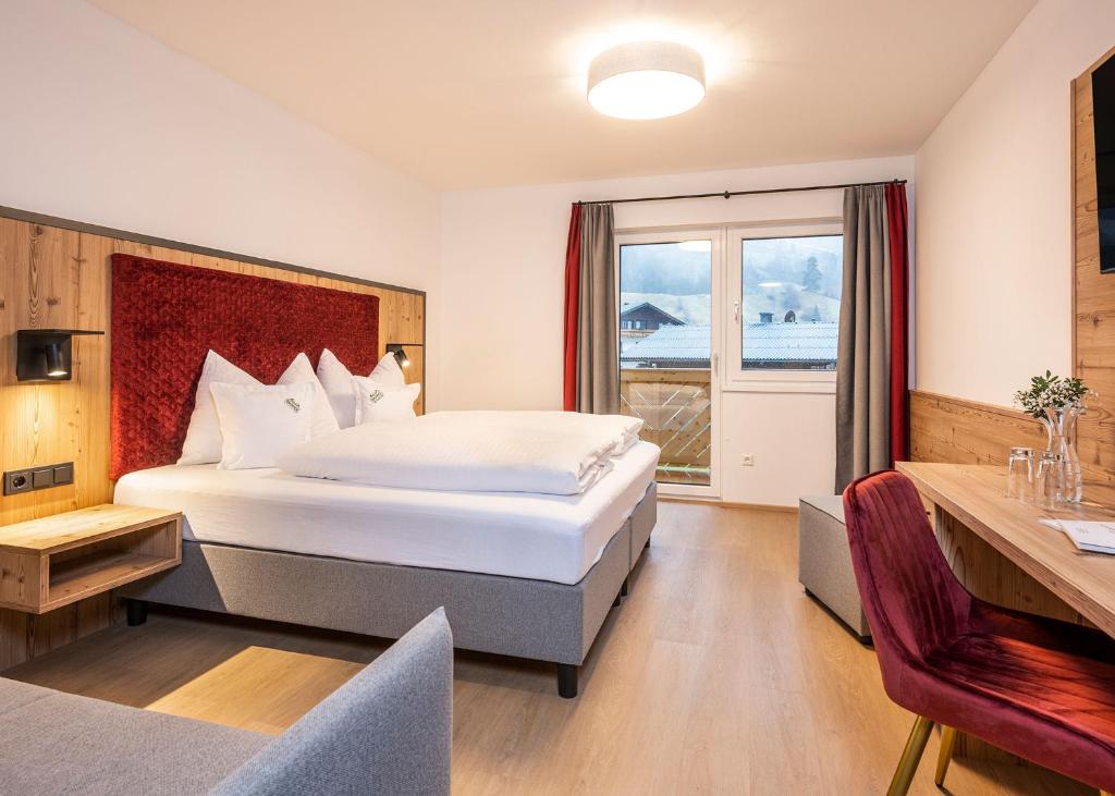 Postel nebo postele na pokoji v ubytování Hotel Brunner - Reiteralm
