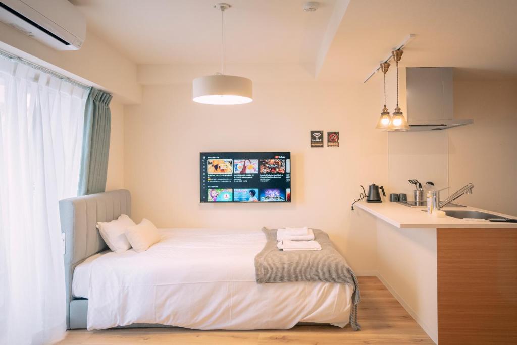 Postel nebo postele na pokoji v ubytování 谷町君HOTEL 心斎橋東32