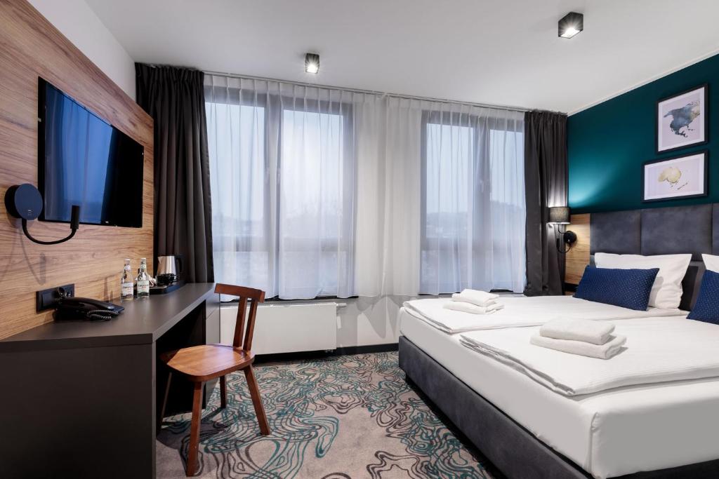 Postel nebo postele na pokoji v ubytování Hotel Kyriad Stargard