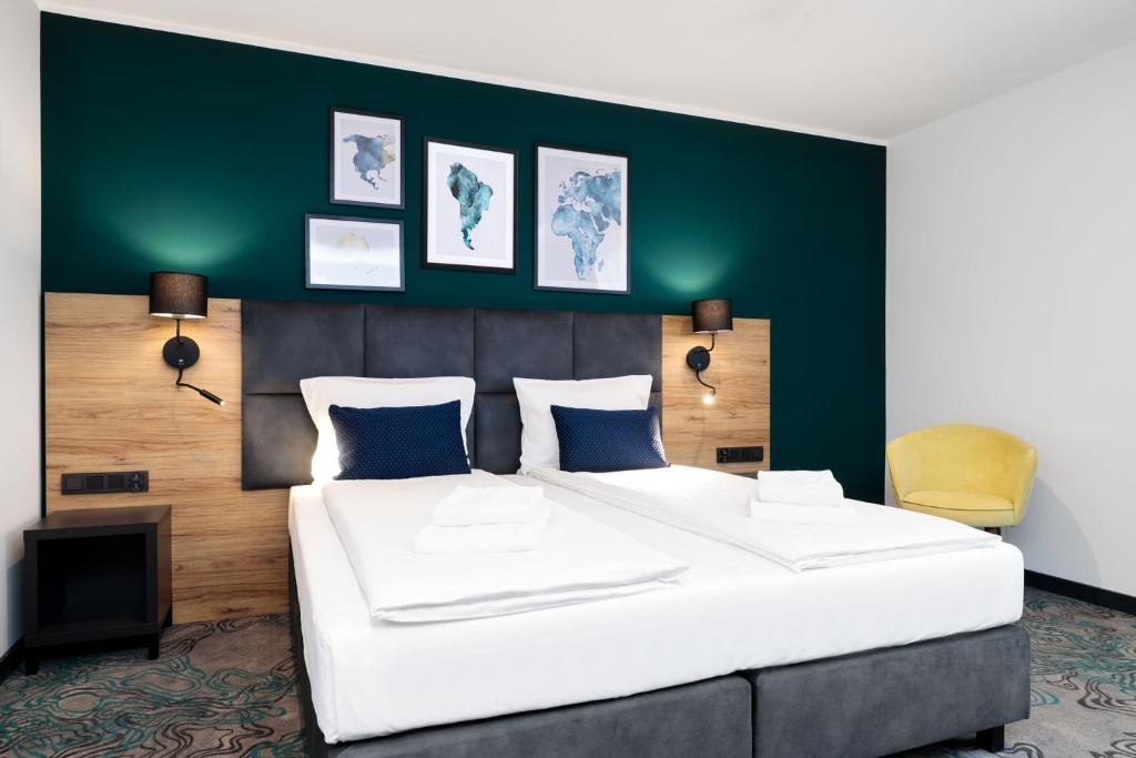 Postel nebo postele na pokoji v ubytování Hotel Kyriad Stargard