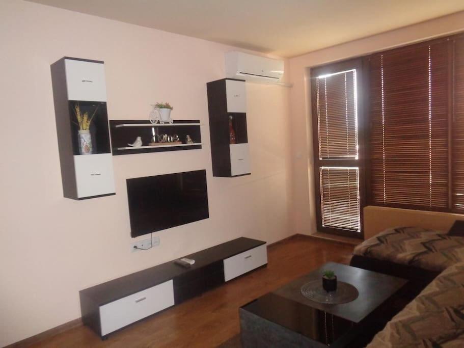 a living room with a flat screen tv on the wall at Home Relax Varna in Varna City