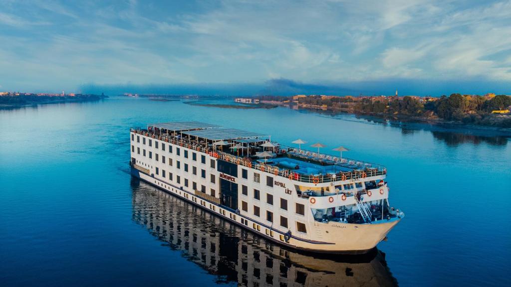 a cruise ship in the water on a river at Mövenpick Royal Lily Monday Four Nights Luxor Friday Three Nights Aswan in Luxor