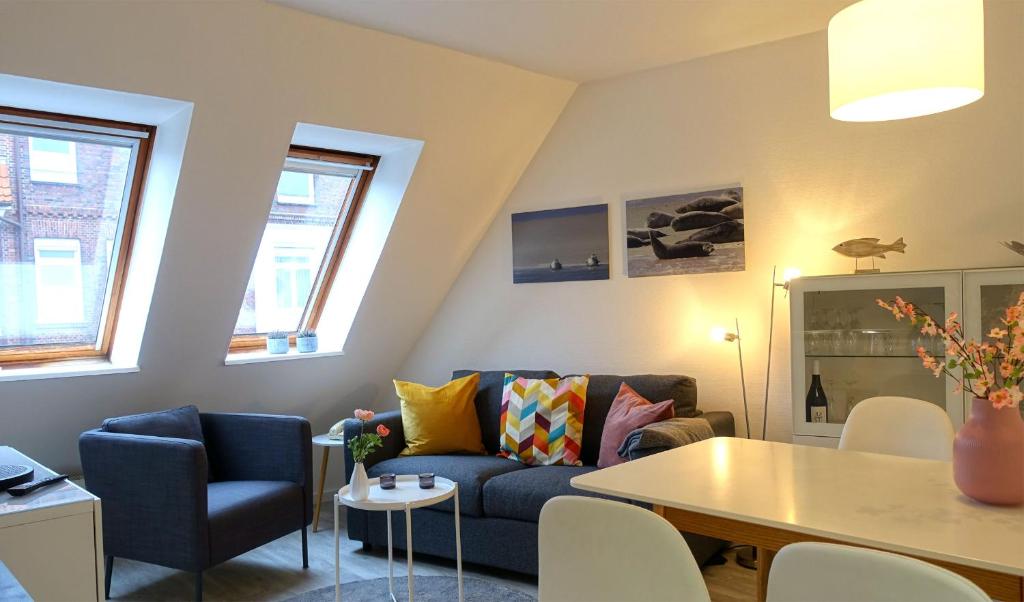 ein Wohnzimmer mit einem Sofa und einem Tisch in der Unterkunft Inselresidenz Strandburg Juist - Ferienwohnung 308 (Ref. 51039) in Juist