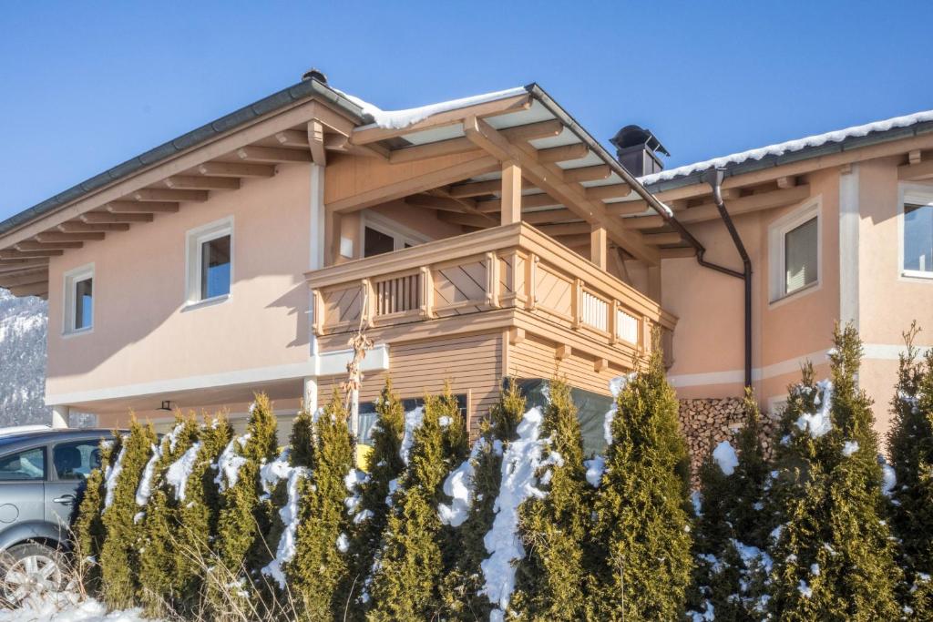 a house with a balcony in front of it at Appartement Julia in Achenkirch