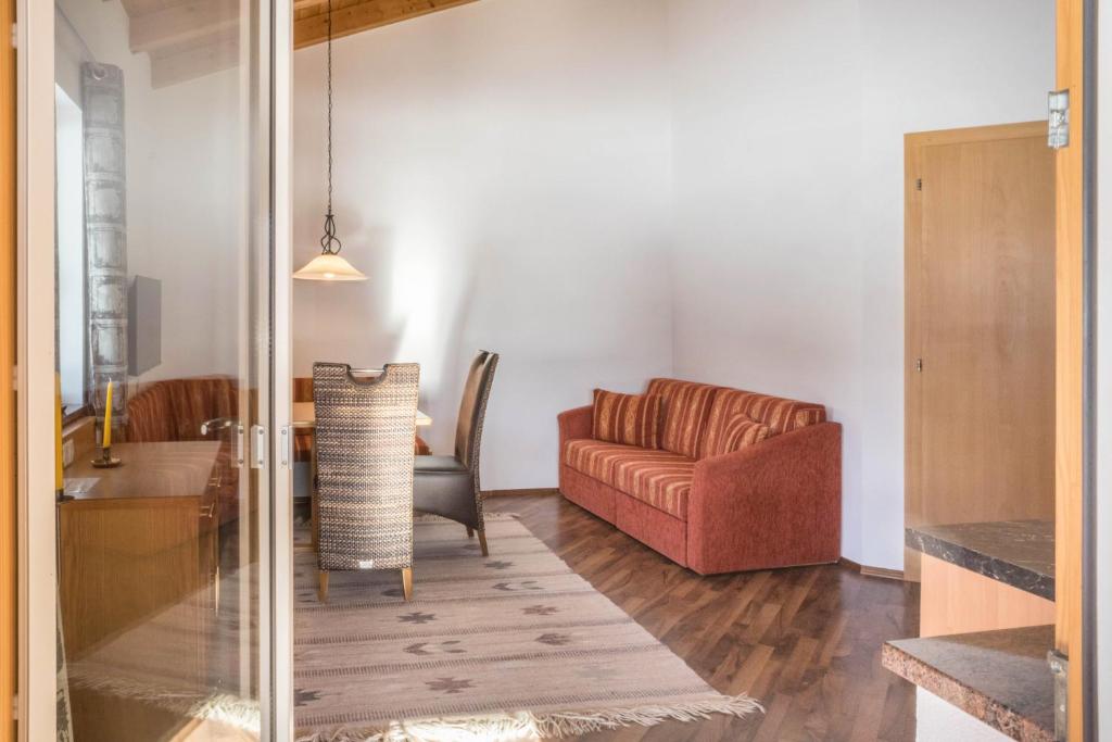a living room with a couch and a table at Appartement Julia in Achenkirch