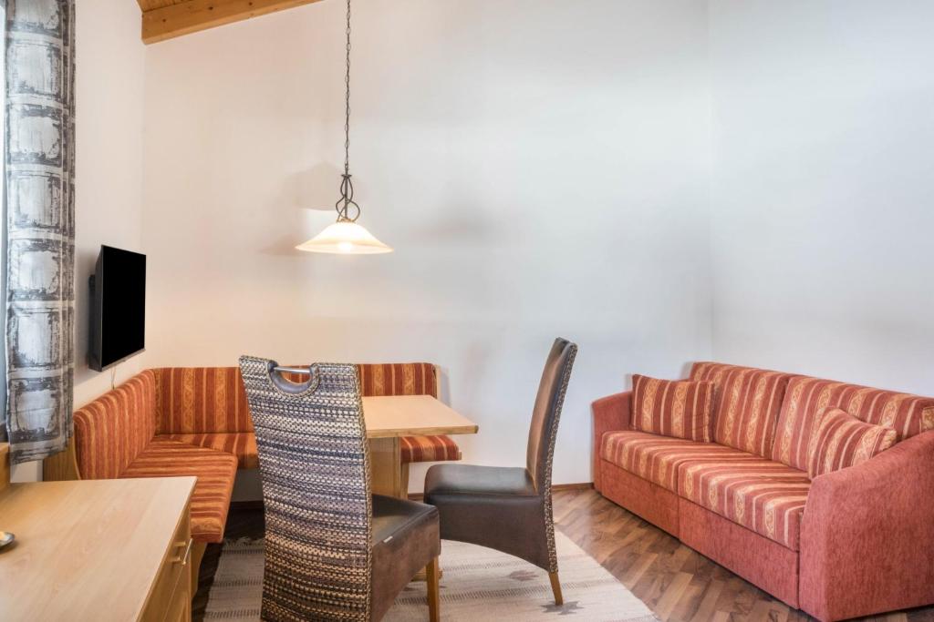 a living room with a couch and a table at Appartement Julia in Achenkirch