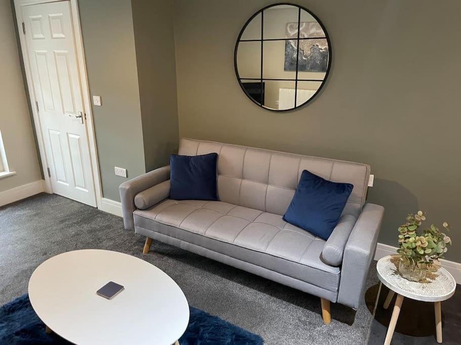 a living room with a couch and a table at Willow House - 2bed Townhouse with free parking!! by Shortstays4U in Kings Lynn