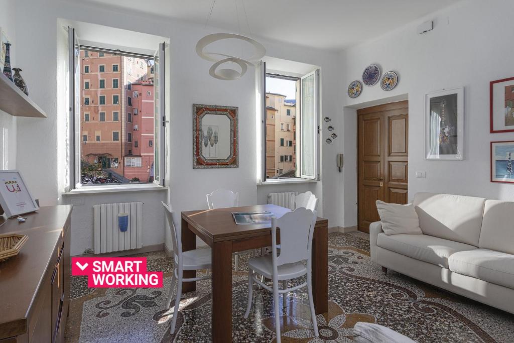 a living room with a table and a couch at La casa di Nanni a Camogli by Wonderful Italy in Camogli