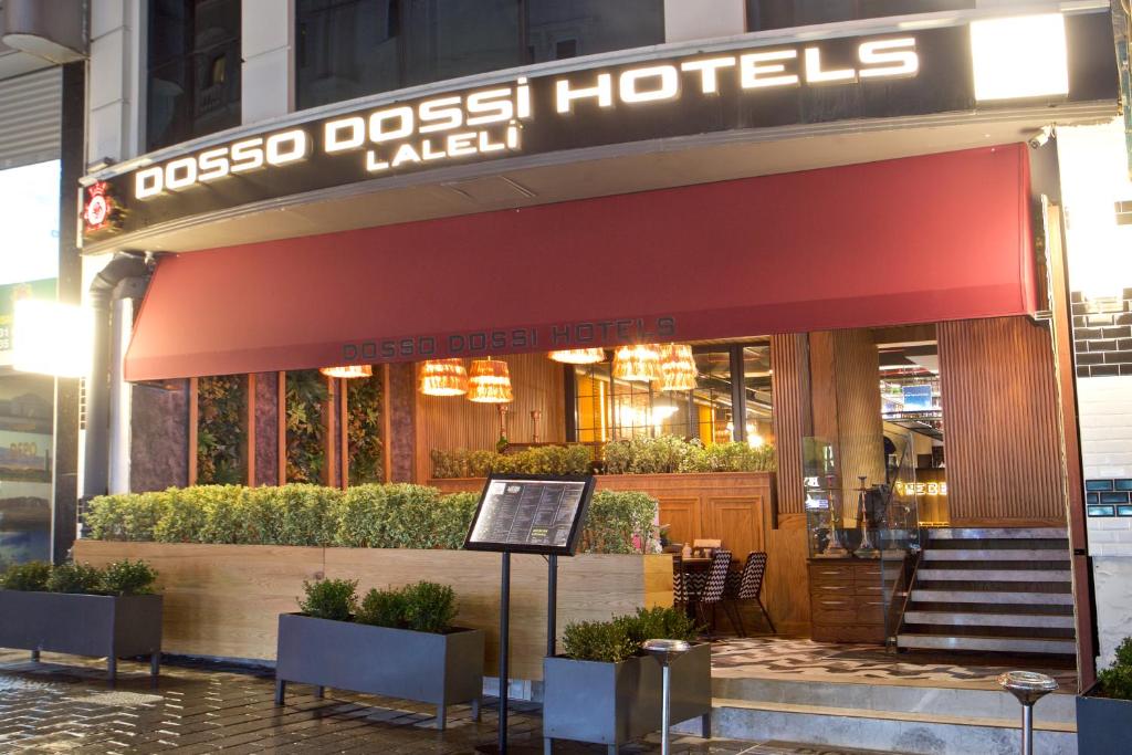 a restaurant with a red awning on a building at Dosso Dossi Hotels Laleli in Istanbul