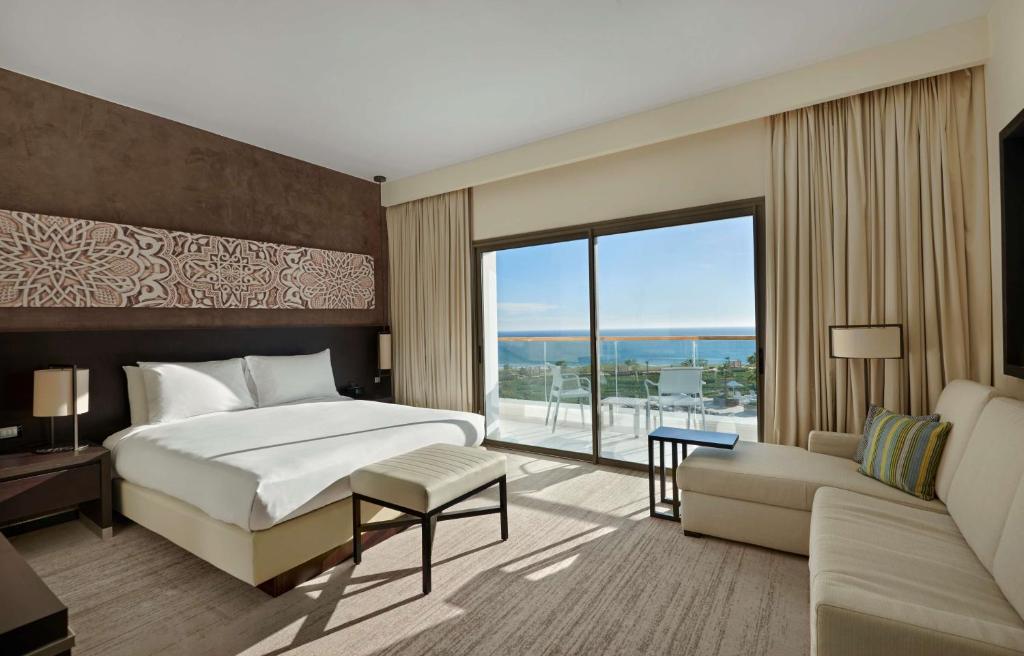 a bedroom with a large bed and a large window at Hyatt Place Taghazout Bay in Taghazout