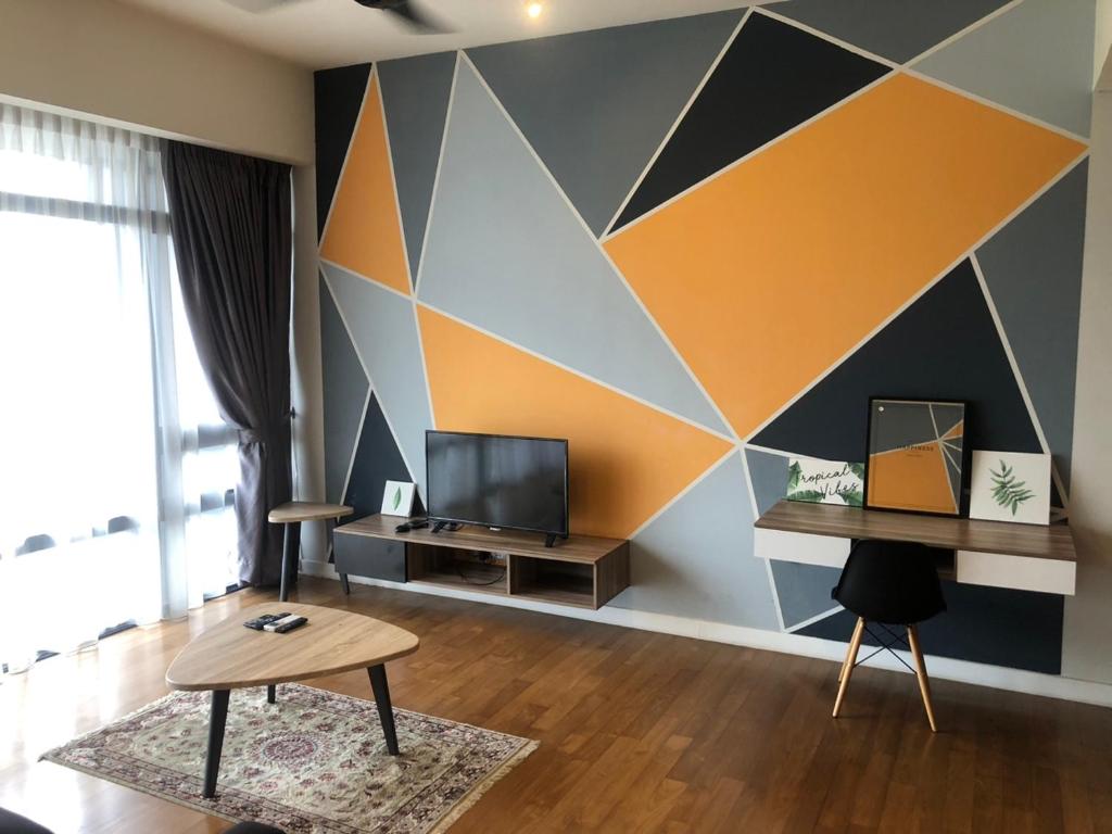 a living room with a geometric wall at Anggun Residences Luxe in Kuala Lumpur