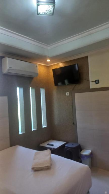 Postel nebo postele na pokoji v ubytování CALDERA PARK HOMESTAY Syariah