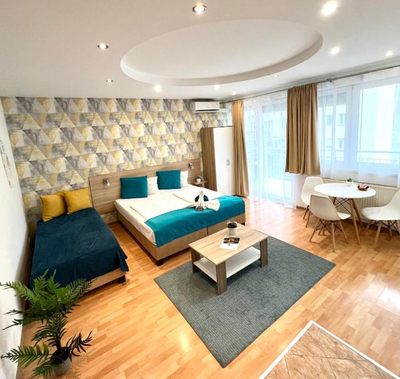 a hotel room with a bed and a table at Star Apartments with free parking in Budapest