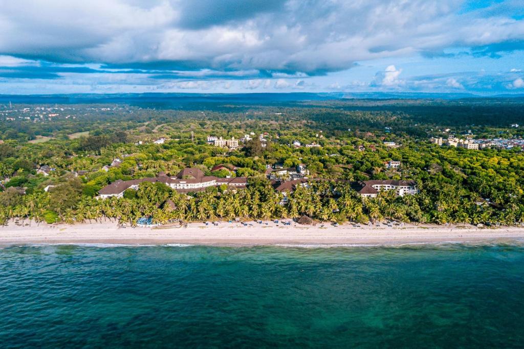 an aerial view of a beach with a resort at Diani Reef Beach Resort & Spa in Diani Beach