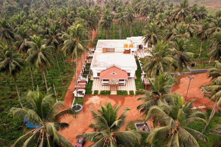 una vista aérea de una casa con palmeras en Monappa Estate - Beautiful Riverside Farm house in Udupi, en Udupi