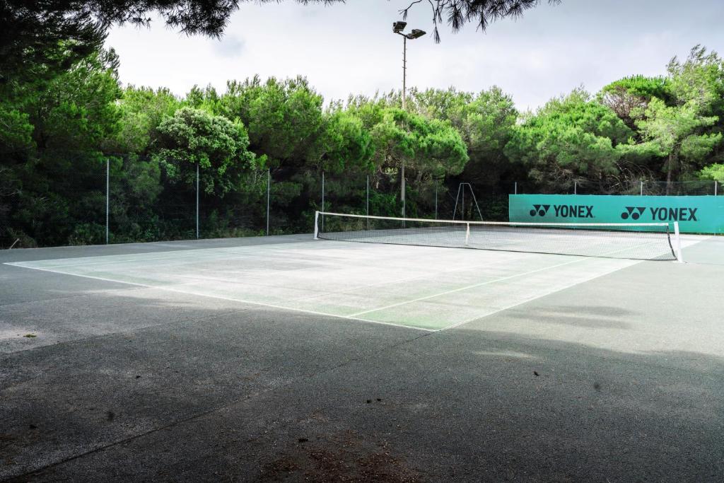 a tennis court with a net on it at Belambra Clubs Presqu&#39;île De Giens - Riviera Beach Club in Hyères
