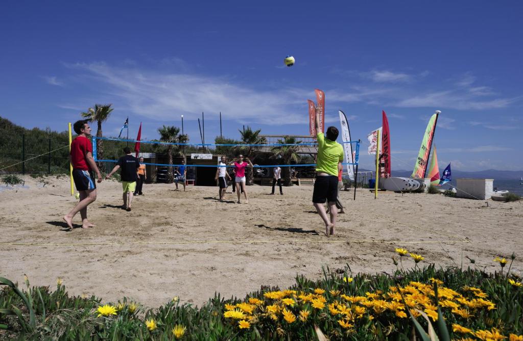 a group of people playing volleyball on the beach at Belambra Clubs Presqu&#39;île De Giens - Riviera Beach Club in Hyères