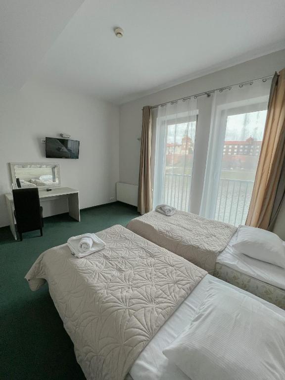 Postel nebo postele na pokoji v ubytování Hotel Poleski
