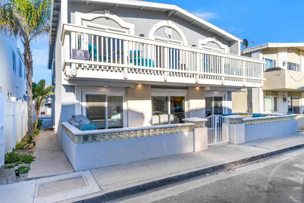 a building with a balcony on a street at Seashore Dreams B - Upper Unit in Newport Beach