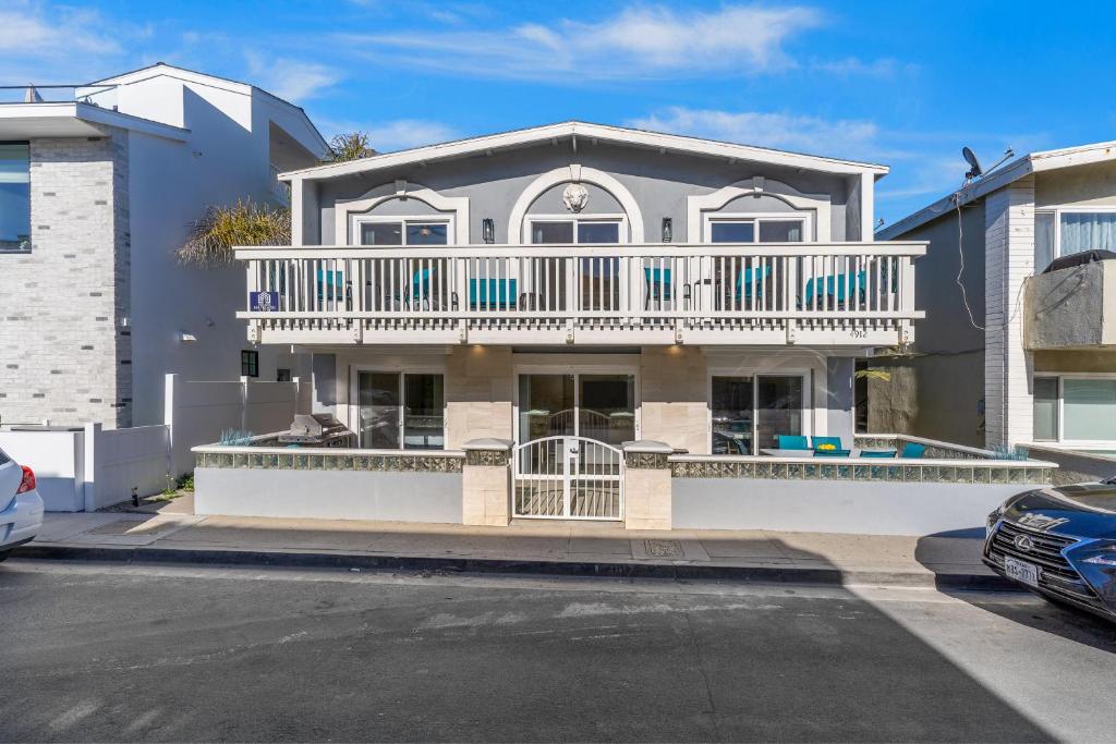 a large white house with a large balcony at 4912 Seashore A Lower in Newport Beach