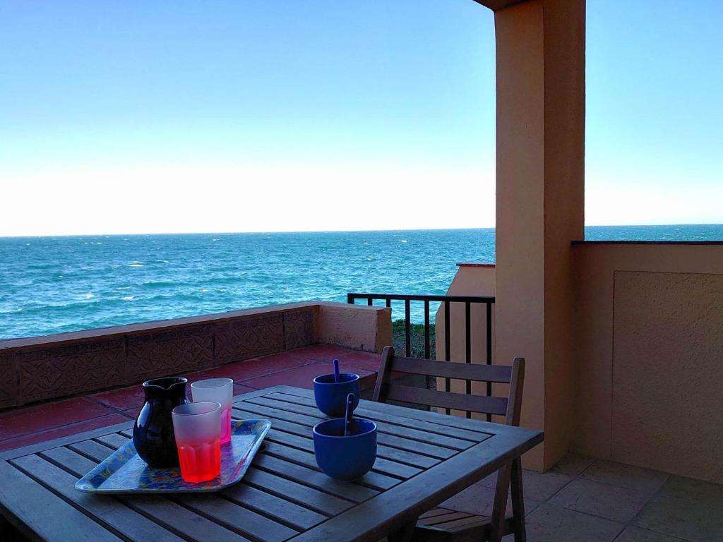 a wooden table with a view of the ocean at 4RB4 Appartement type T2 bord de mer ACCES PLAGE DIRECT in Collioure