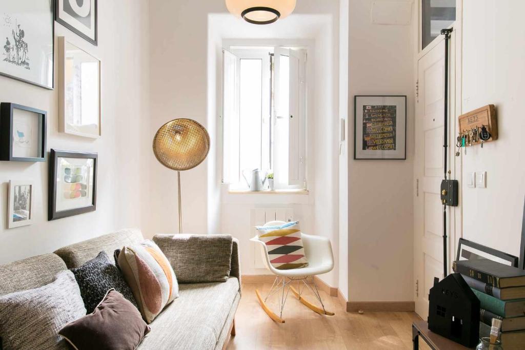 a living room with a couch and a chair at St Amaro- Chic Terrace Studio Lisbon Congress in Lisbon