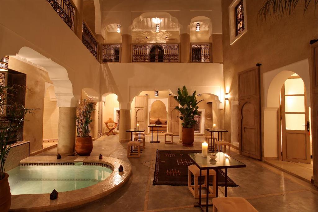 a large room with a swimming pool in a building at Riad Dar Ten in Marrakech