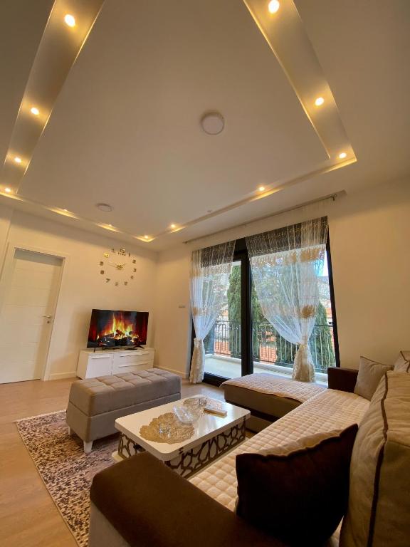 a living room with a couch and a fireplace at Apartman EN in Trebinje