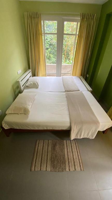 Postel nebo postele na pokoji v ubytování Vista House Kandy