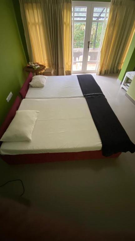 Postel nebo postele na pokoji v ubytování Vista House Kandy