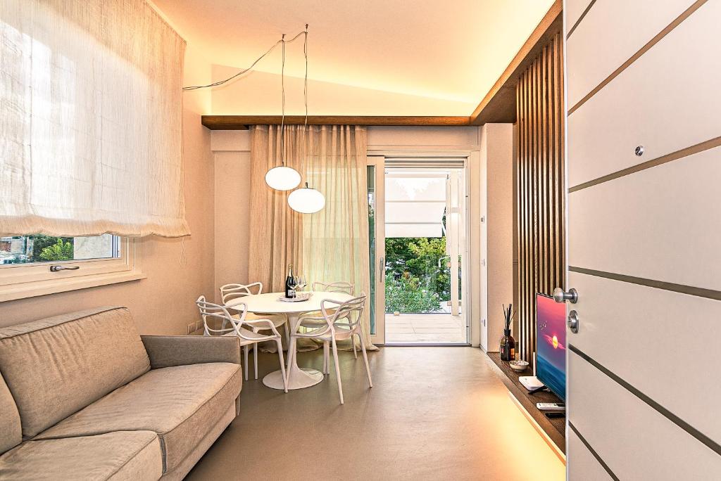 a living room with a couch and a table at Sea Holidays Apartment in Marina di Pietrasanta
