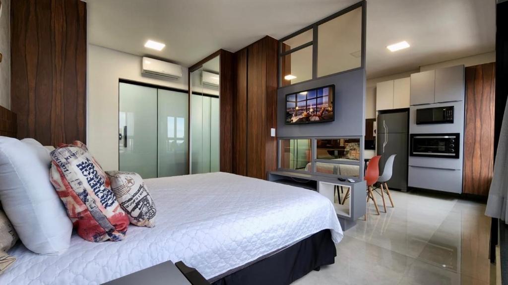 1 dormitorio con 1 cama grande y cocina en Estúdio Ultra Luxo com Vista Panorâmica en Campo Grande
