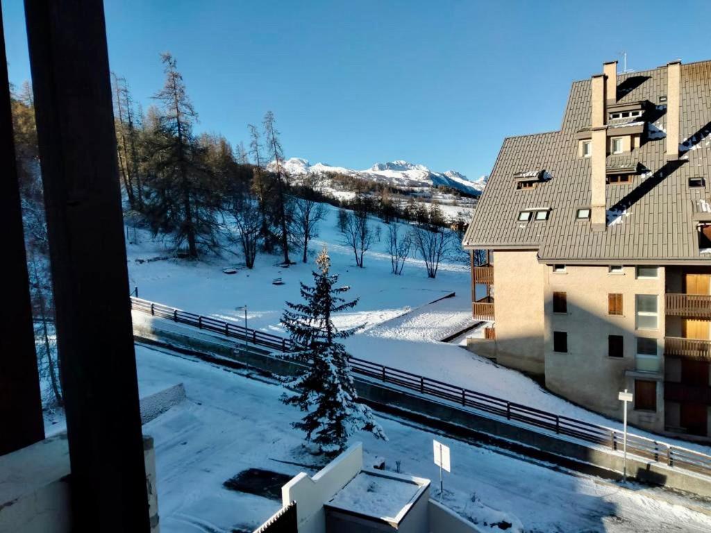 a winter view from a balcony of a building at Studio au pied des pistes in Enchastrayes