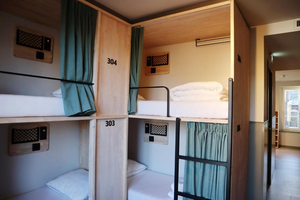 a group of bunk beds in a room at The Bee Hostel in Amsterdam