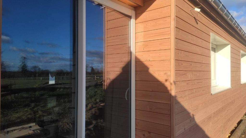 a side view of a building with a window at Eco-gîte à la Ferme d'Elles in Saint-André-de-lʼÉpine