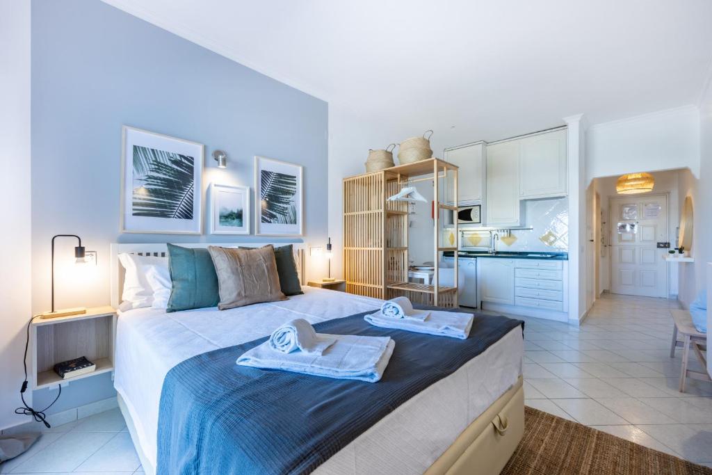 a bedroom with a large bed with towels on it at Studio Marina View by Seewest in Lagos