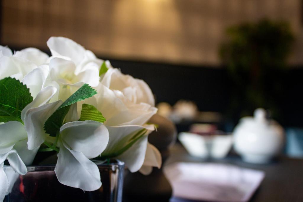 a vase filled with white flowers sitting on a table at Kintrae B&B in Buckie